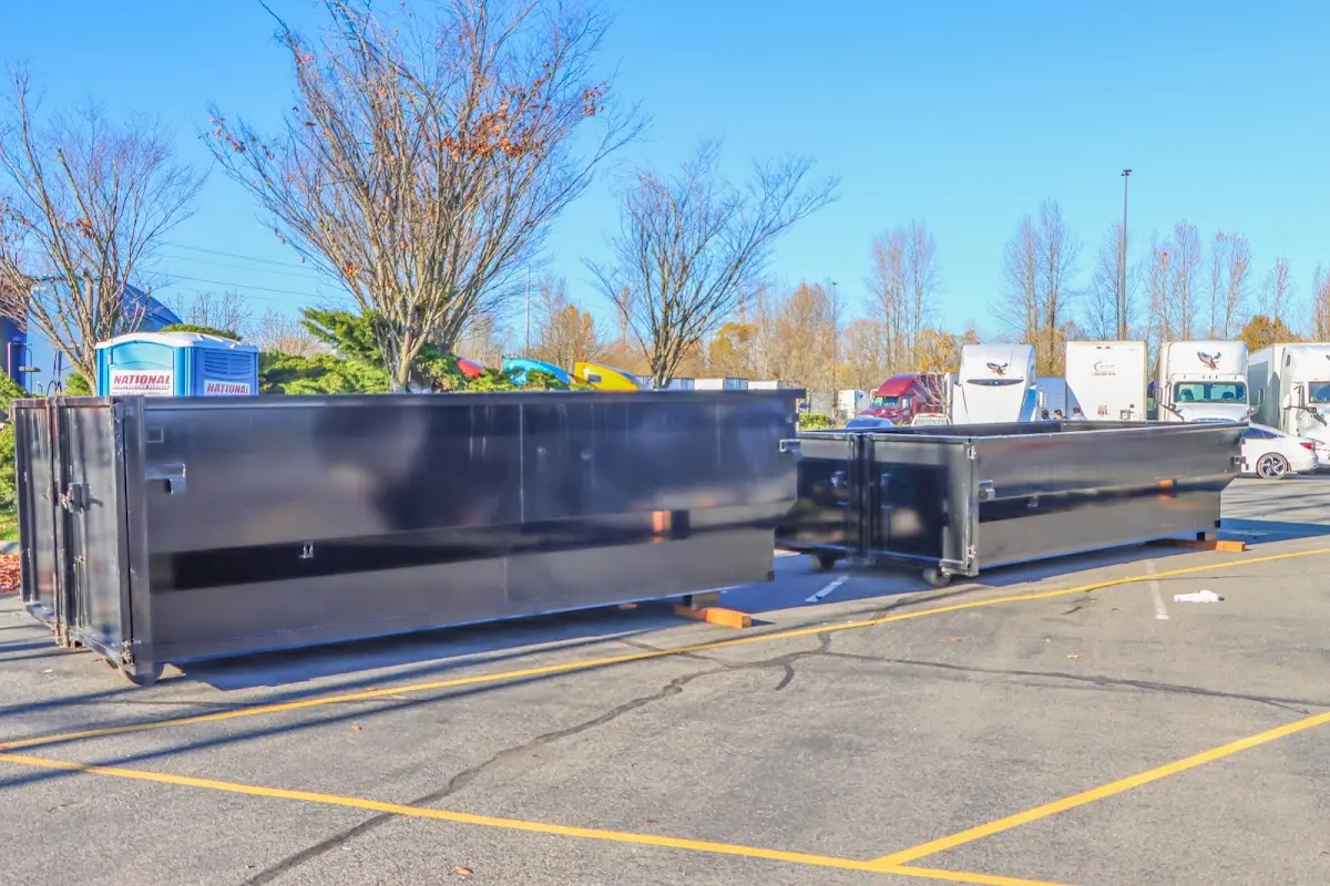 Professional dumpster rental service with roll-off container on residential driveway in Robinson